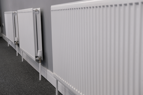 Row of panel radiators with thermostatic radiator valves